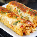 Golden-baked savory roll sliced to reveal layers of potato dough, creamy chicken filling, shredded mozzarella, and crispy bacon, served on a wooden board.