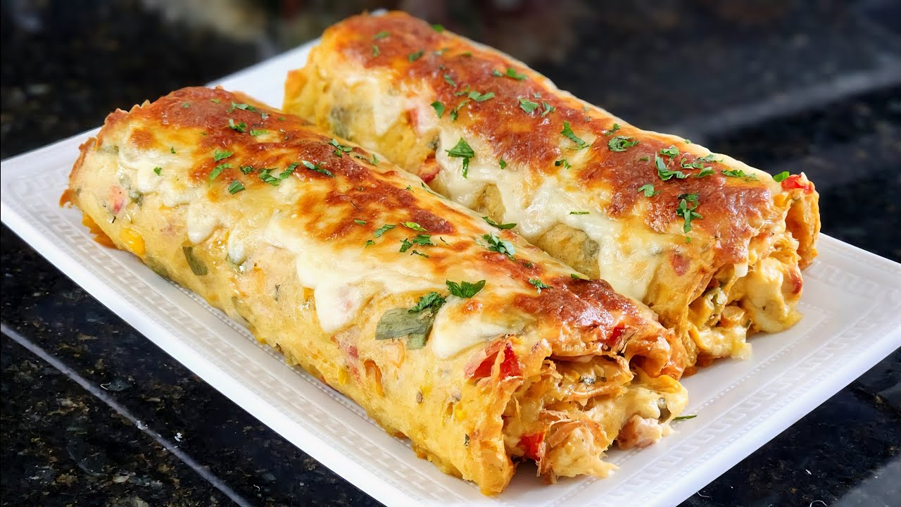 Golden-baked savory roll sliced to reveal layers of potato dough, creamy chicken filling, shredded mozzarella, and crispy bacon, served on a wooden board.